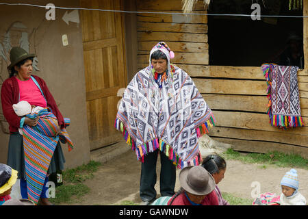 Wedding ceremony preparaton. View of the bride`s father wearing handwoven poncho and chullo - knitted hat with earflaps, Paru Paru, the highest-altitude community in La Parque de la Papa, Andes Mountain, Peru Stock Photo